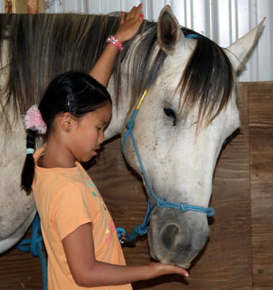 girl with horse at Dakota Stables